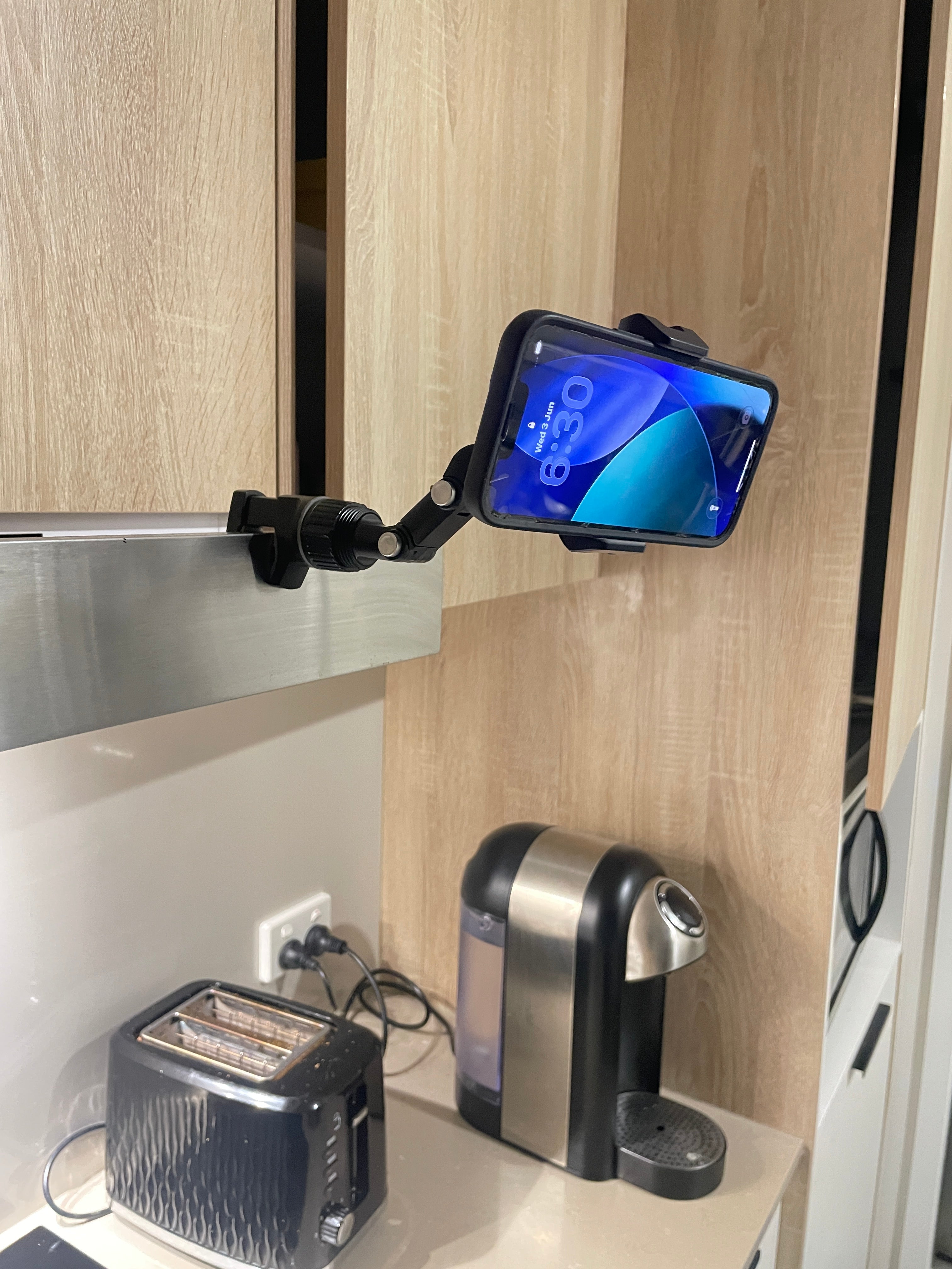 QENTROVA universal phone holder for car, motorcycle, bike, and desk, showing a secure mount with a smartphone in landscape orientation.