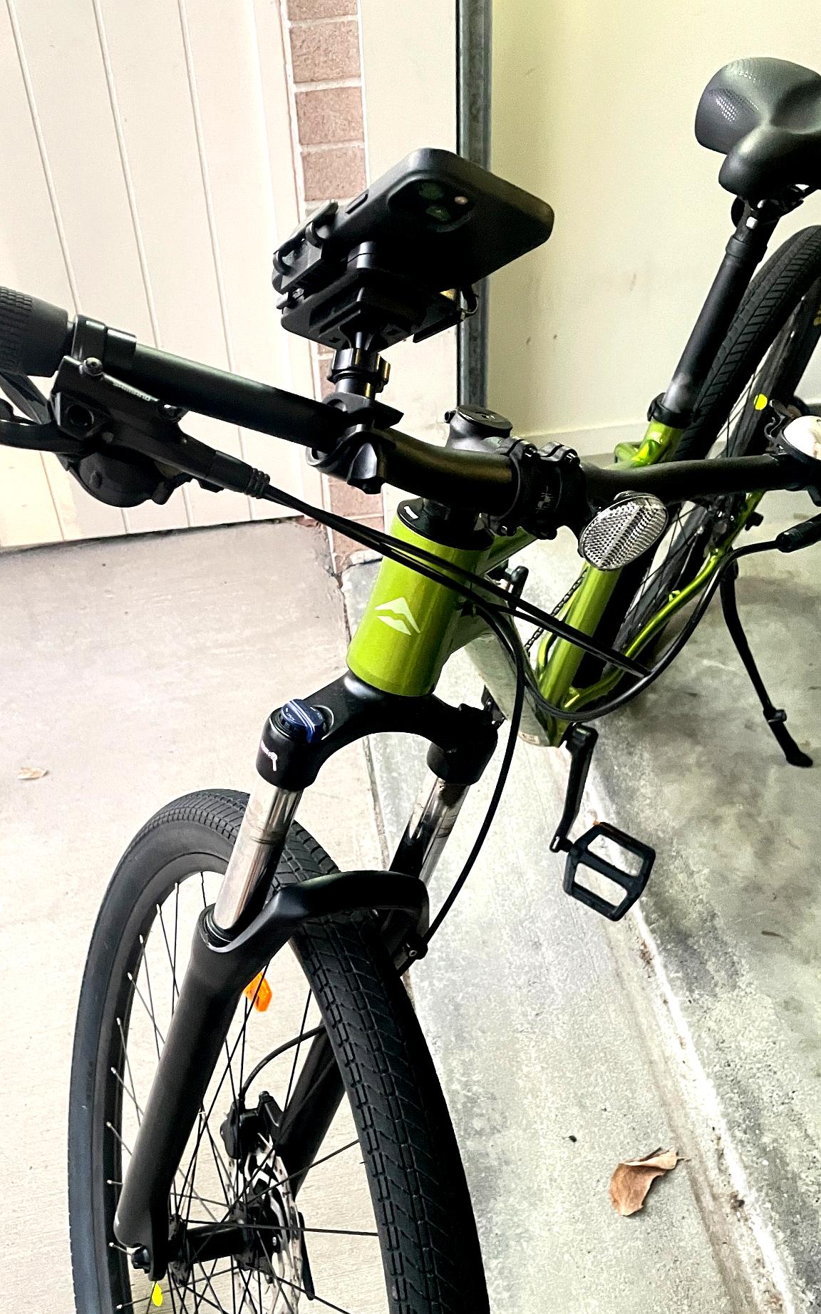 QENTROVA universal phone holder secured to a bicycle handlebar, side angle view.