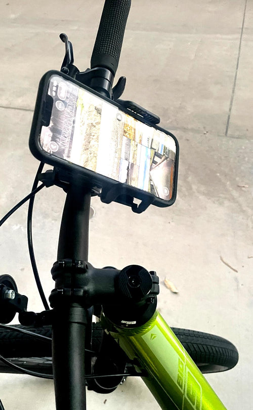 QENTROVA universal phone holder mounted on a bicycle handlebar, securely holding a smartphone